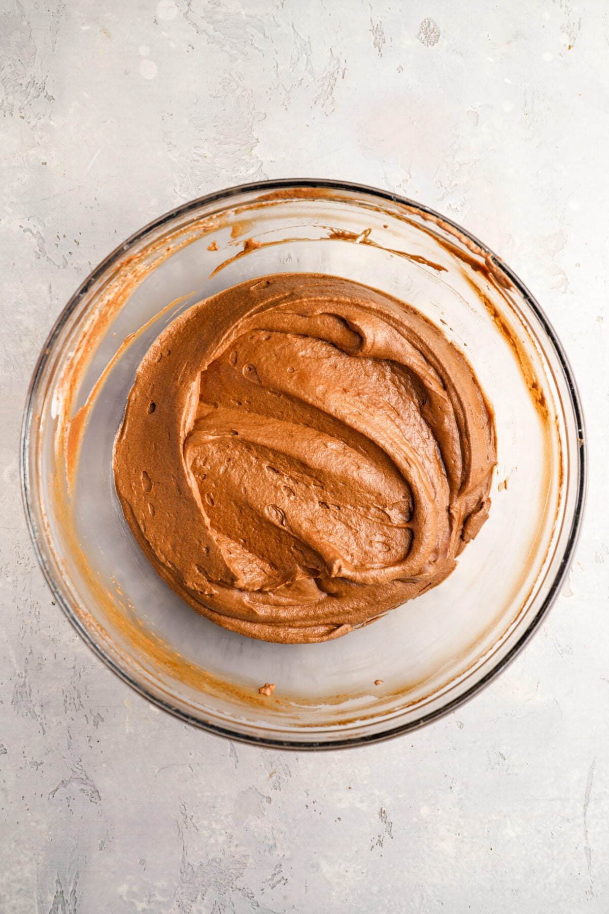 glass bowl with whipped cream combined with chocolate mixture