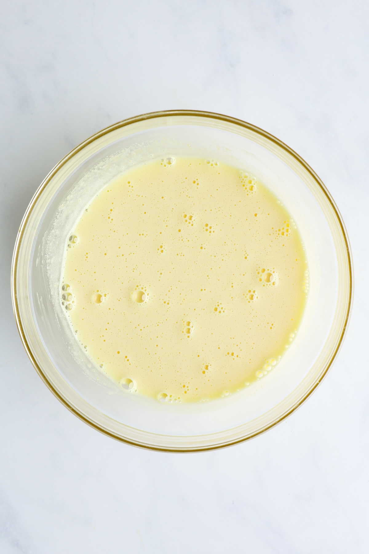 hot milk combined with sugar, cornstarch, salt, and egg yolks in medium bowl
