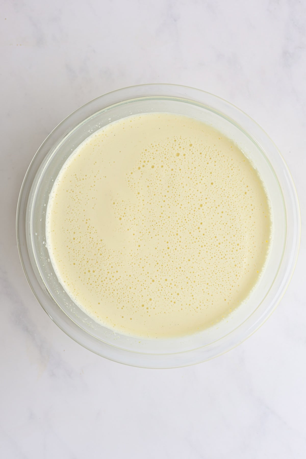 1/2 cup warm milk combined with sugar/egg mixture in glass bowl