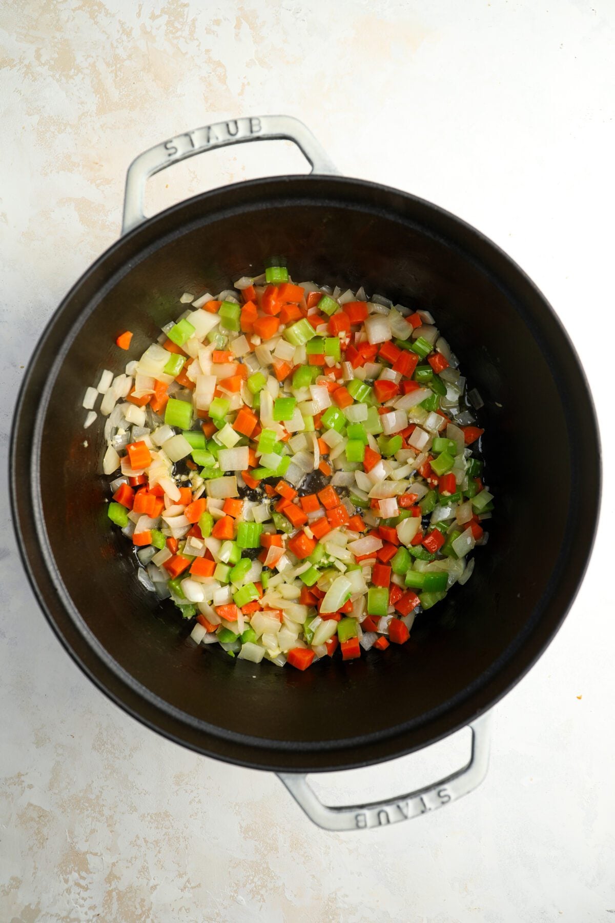 dutch oven with garlic added to onion, celery, and carrots