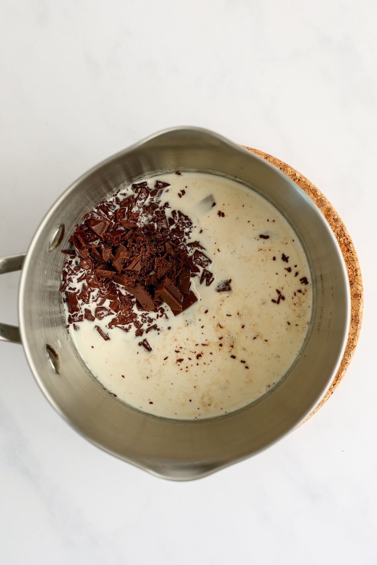 small saucepan with cream, chocolate, and salt (unmixed)