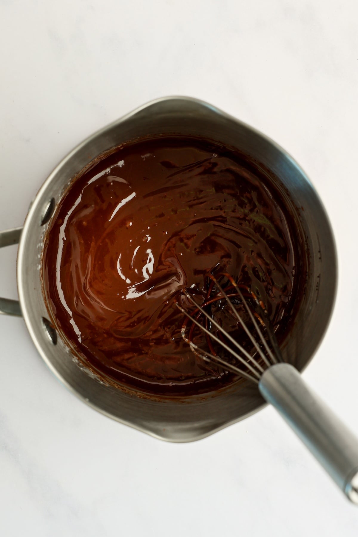 small saucepan with cream, chocolate, and salt combined
