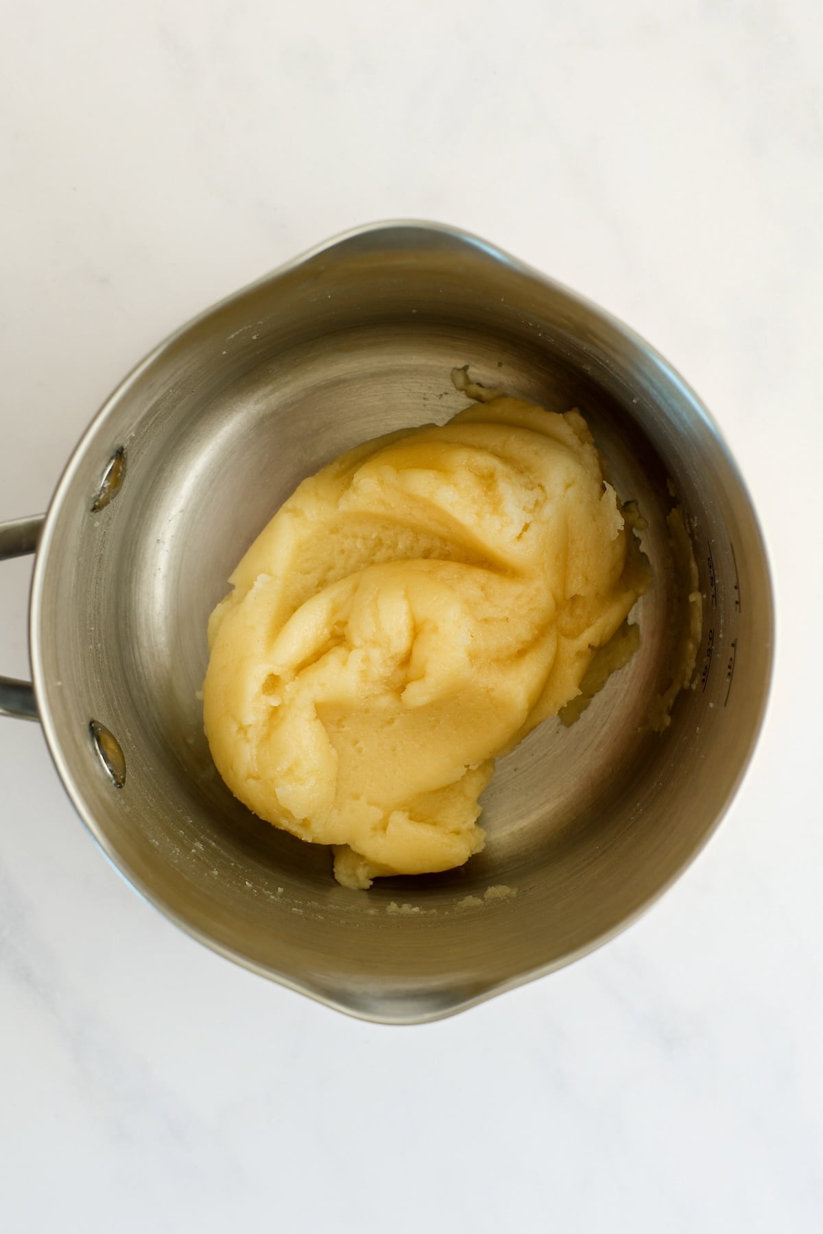 medium saucepan with flour and milk butter mixture combined into a dough ball