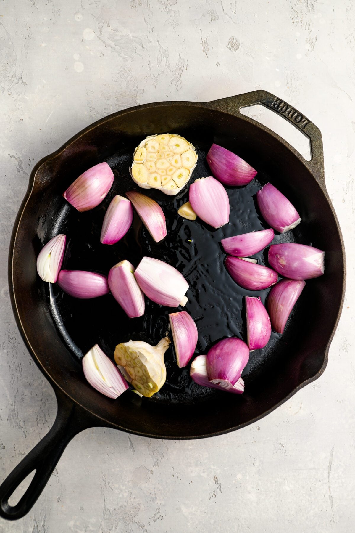 shallots, garlic, and olive oil in roasting pan