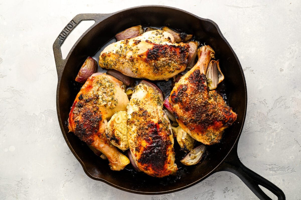 cooked chicken, garlic, and shallots in roasting pan