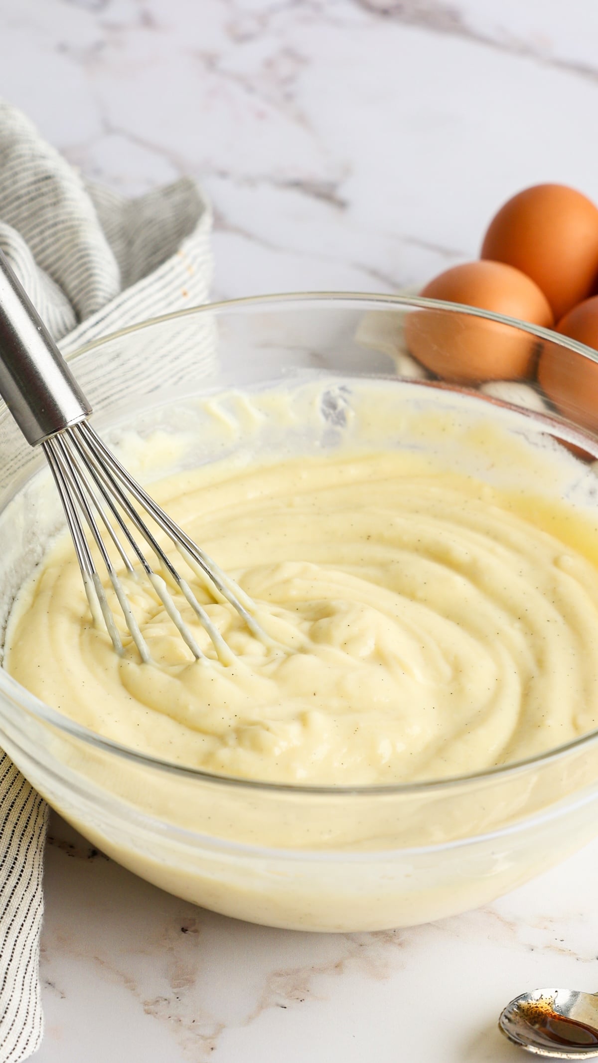 chilled pastry cream in glass bowl with whisk 