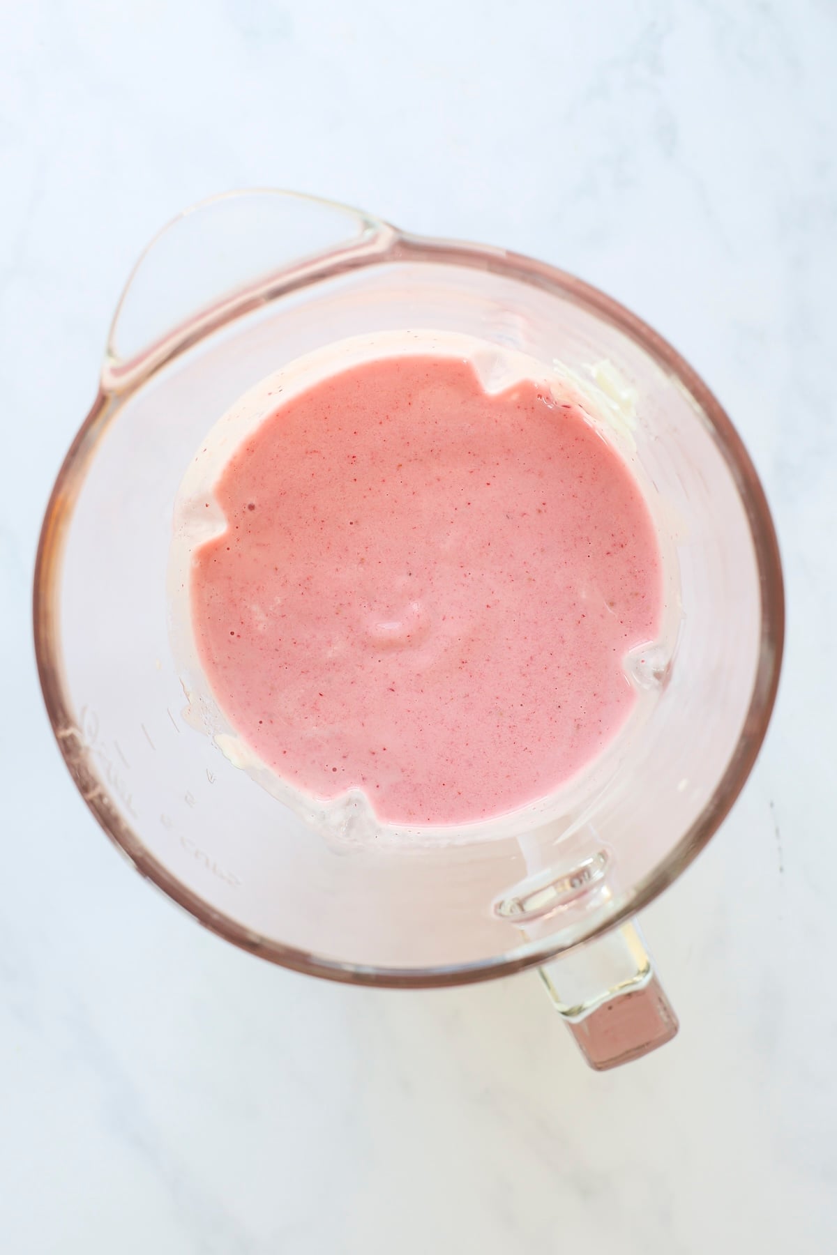 banana, strawberries, yogurt, milk, and honey blended together in blender