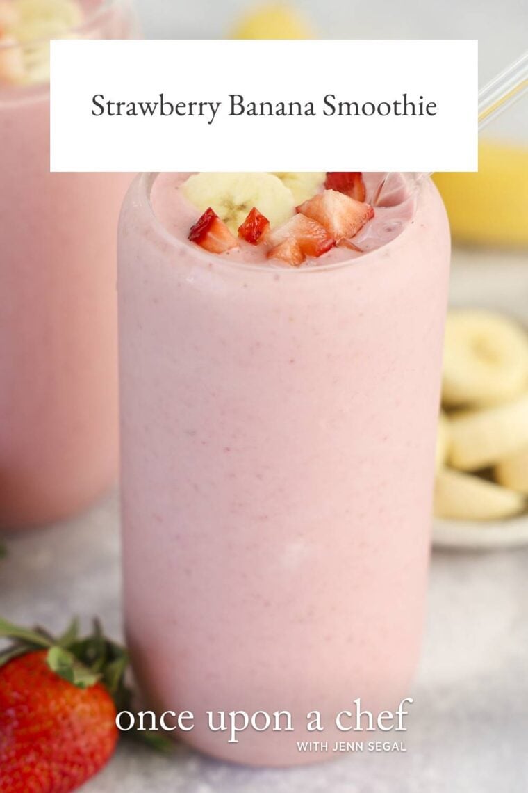 clear glass with strawberry banana topped with diced strawberry and banana