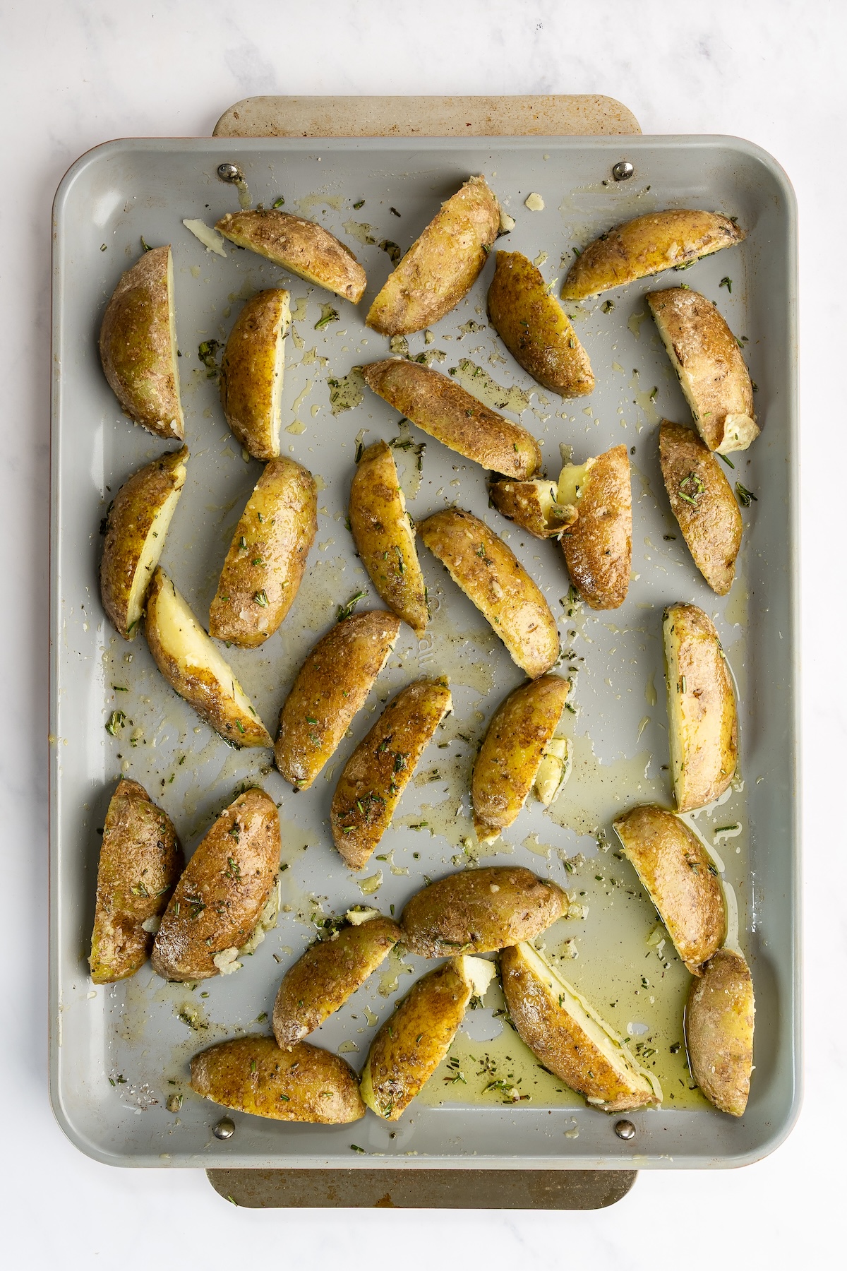 sheet pan with partially baked potato wedges
