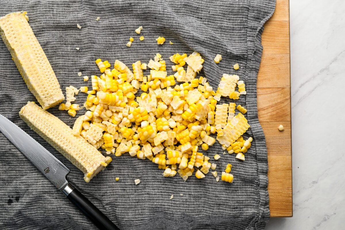 cutting corn kernels off cob on dish towel