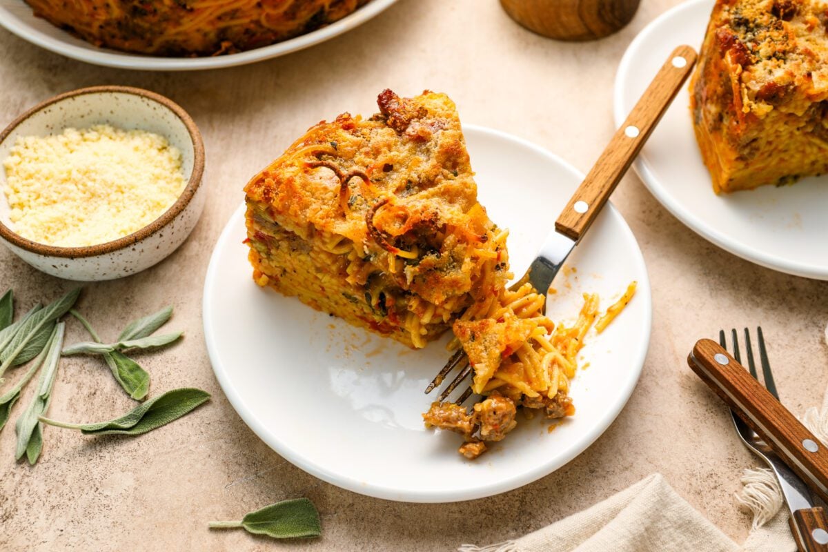 slice of spaghetti pie on plate with a fork