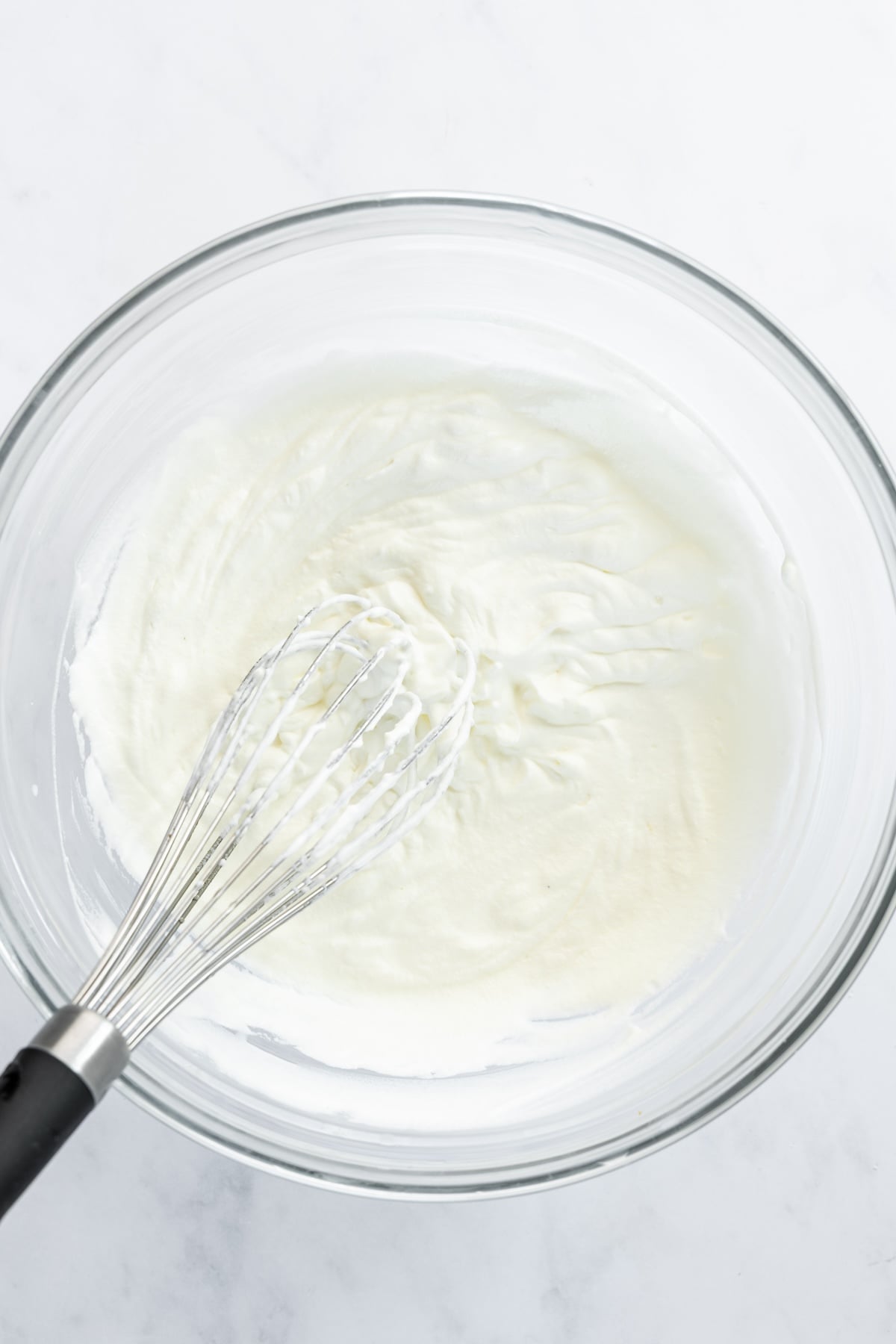 medium bowl with heavy cream whipped to stiff peaks