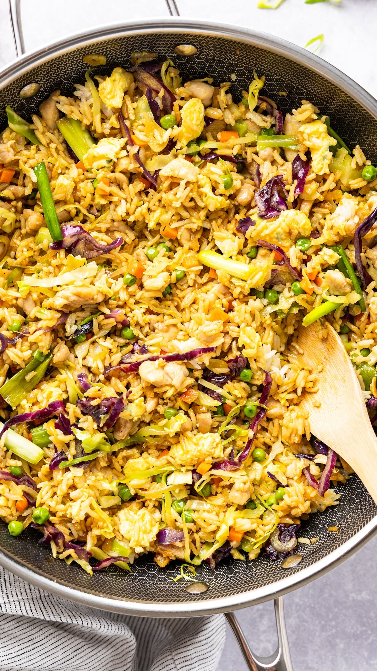 nasi goreng in skillet with wooden spoon