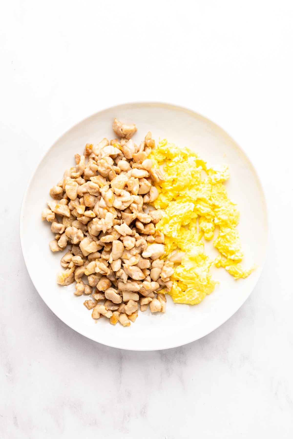 cooked chicken and eggs on white plate