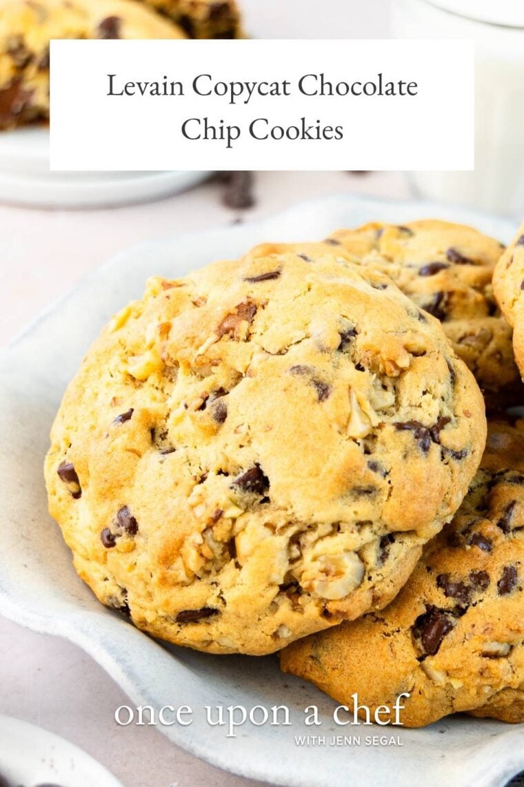 white plate with Levain chocolate chip cookies piled on top