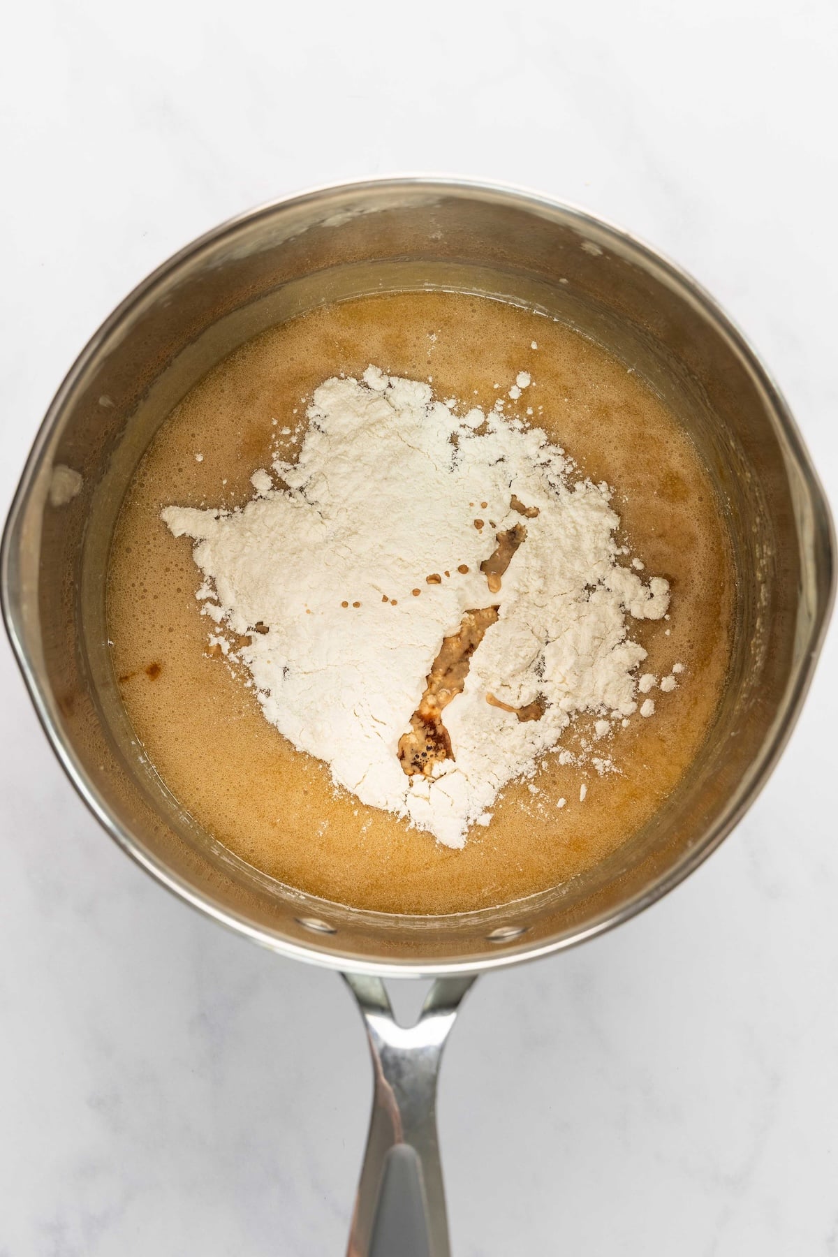 flour and vanilla added to butter, brown sugar, corn syrup, and salt mixture