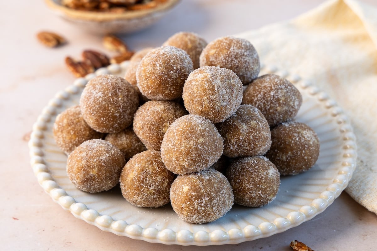 rum balls piled onto decorative white plate