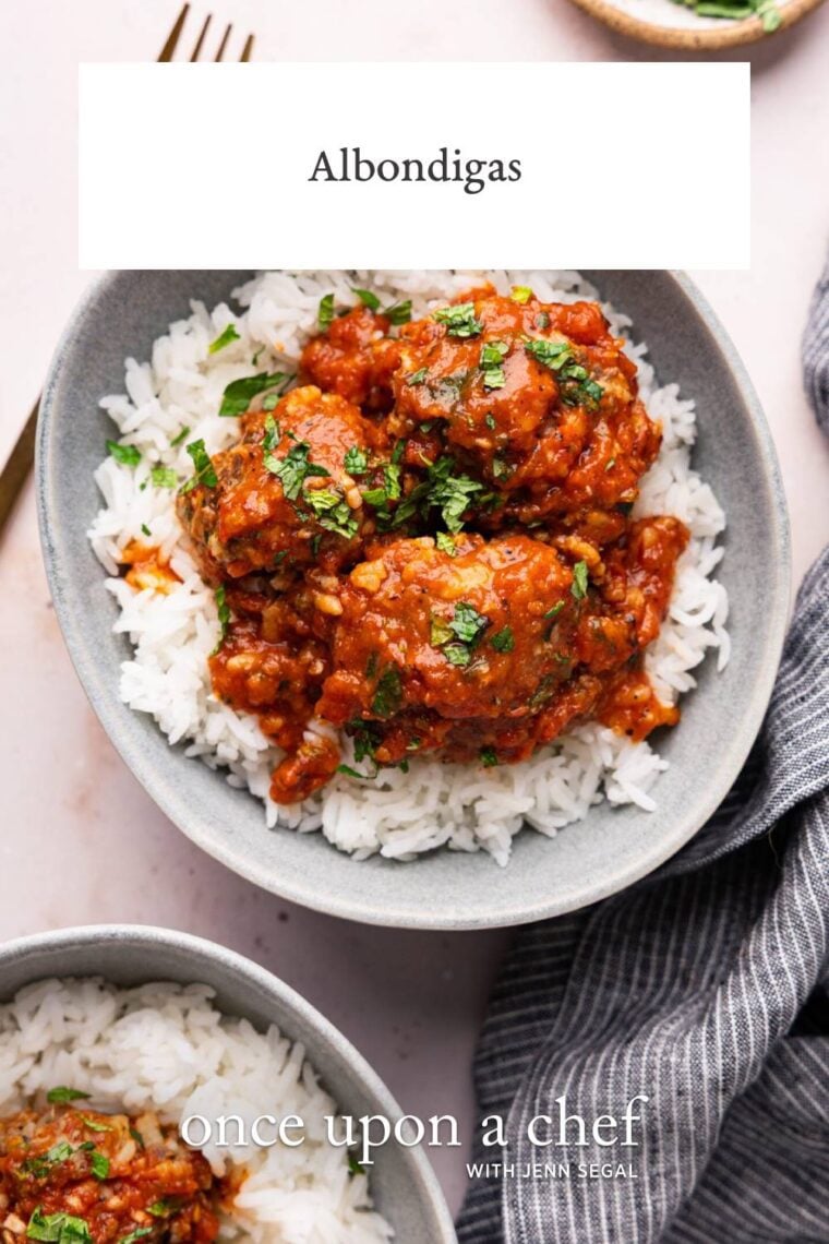 gray bowl with white rice topped with albondigas and sauce