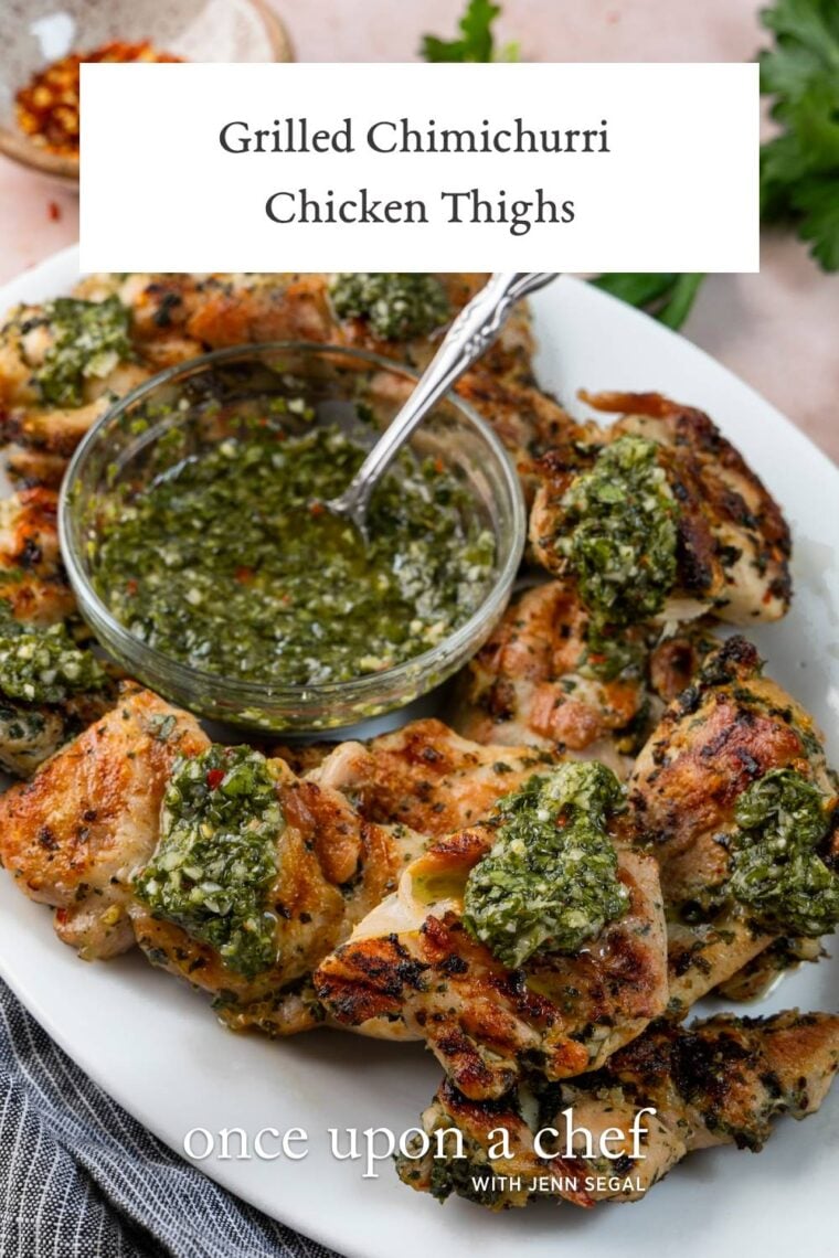white oval platter with grilled chicken and chimichurri sauce in a bowl
