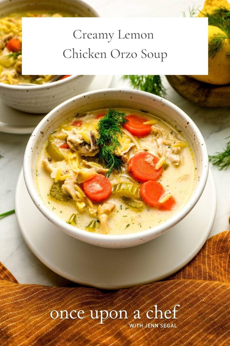 2 white bowls filled with creamy lemon chicken orzo soup and garnished with fresh dill
