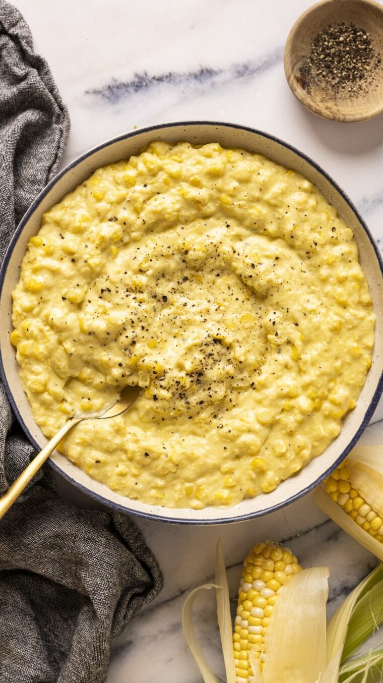 creamed corn in bowl with fresh black pepper