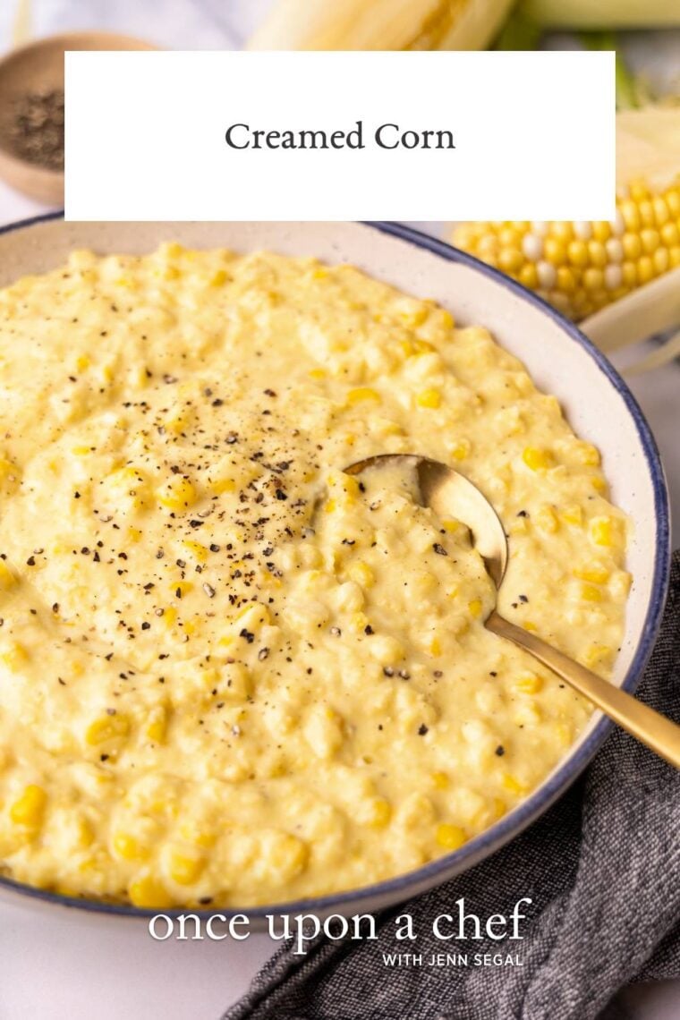 creamed corn in white bowl on gray napkin