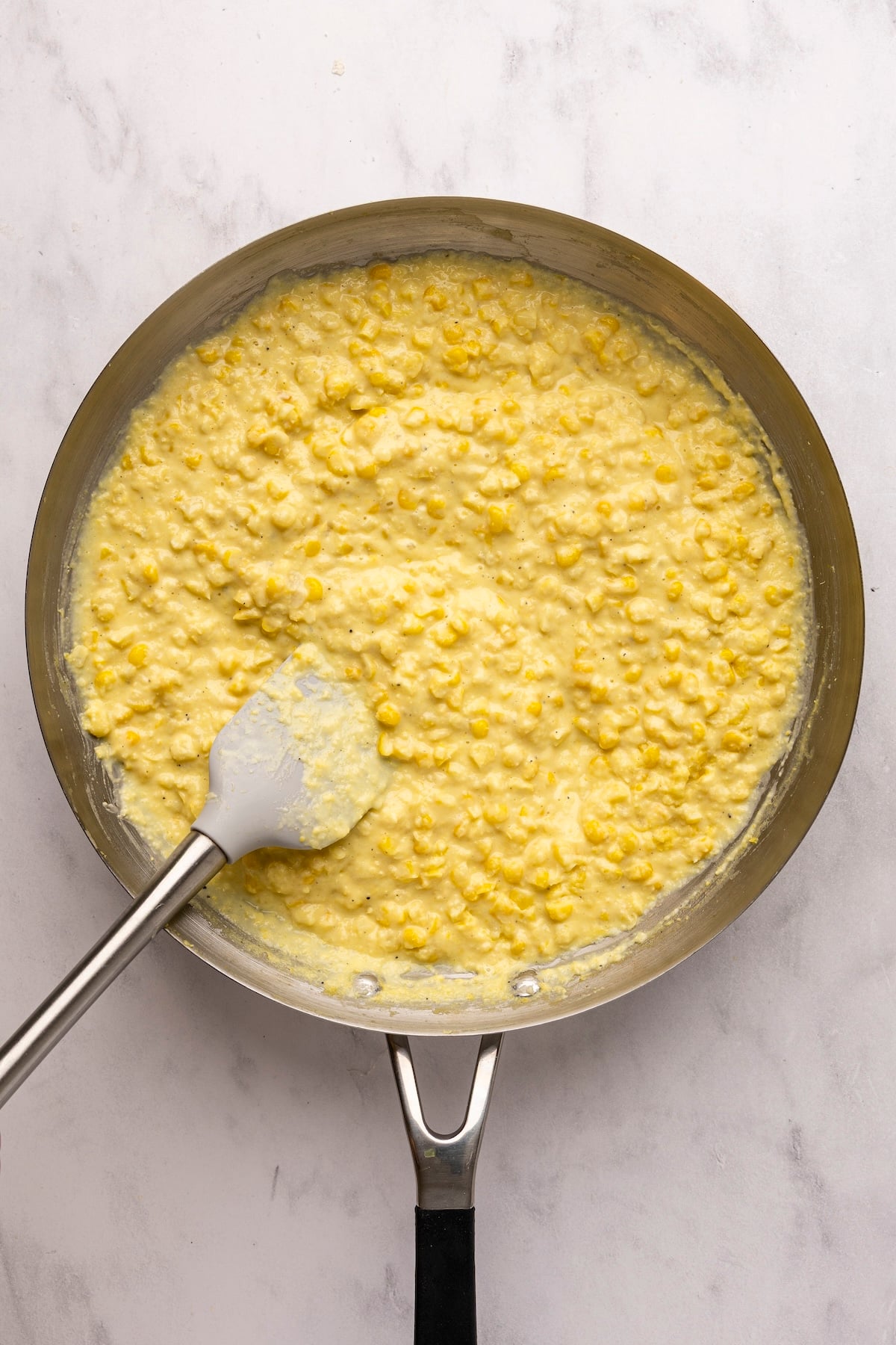 corn puree and fresh corn mixed together in large skillet