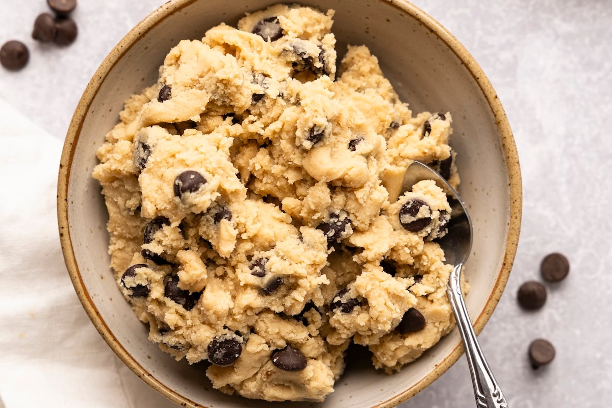 cream colored bowl with edible cookie dough and spoon