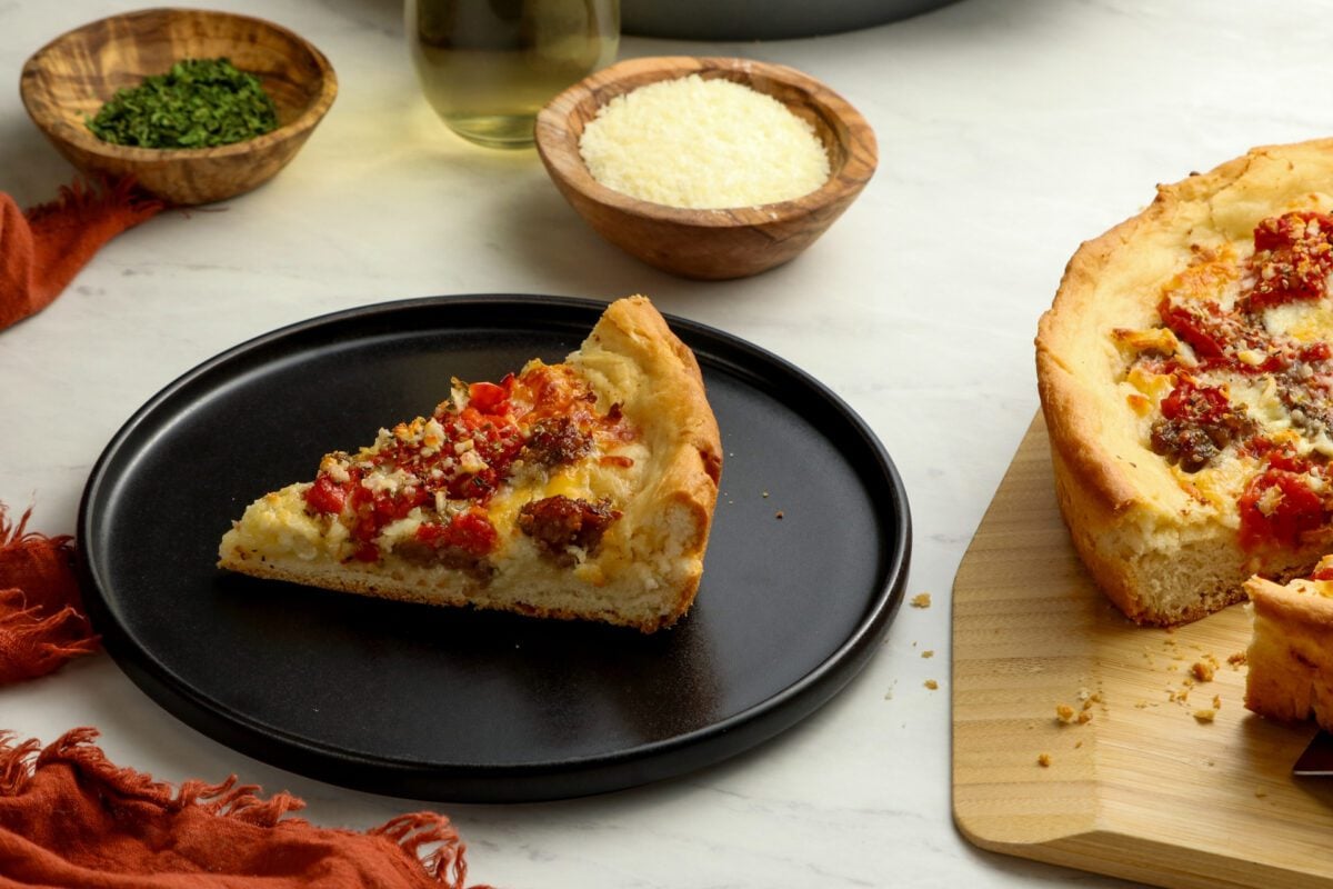 slice of deep dish pizza on black plate