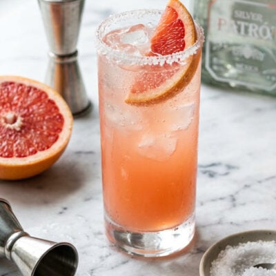 marble counter with paloma cocktail garnished with grapefruit slice