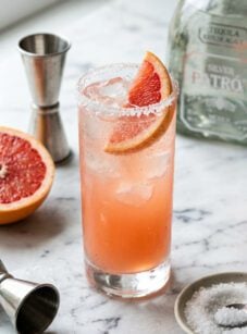 marble counter with paloma cocktail garnished with grapefruit wedge