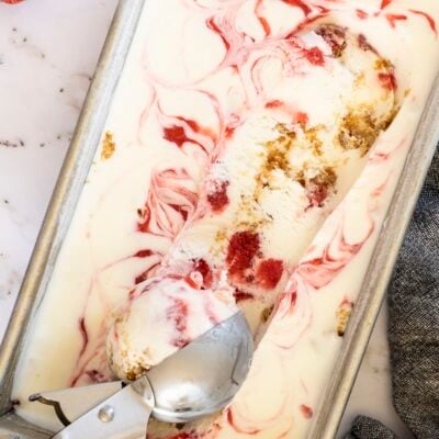 Strawberry Cheesecake Ice Cream in loaf pan with ice cream scoop