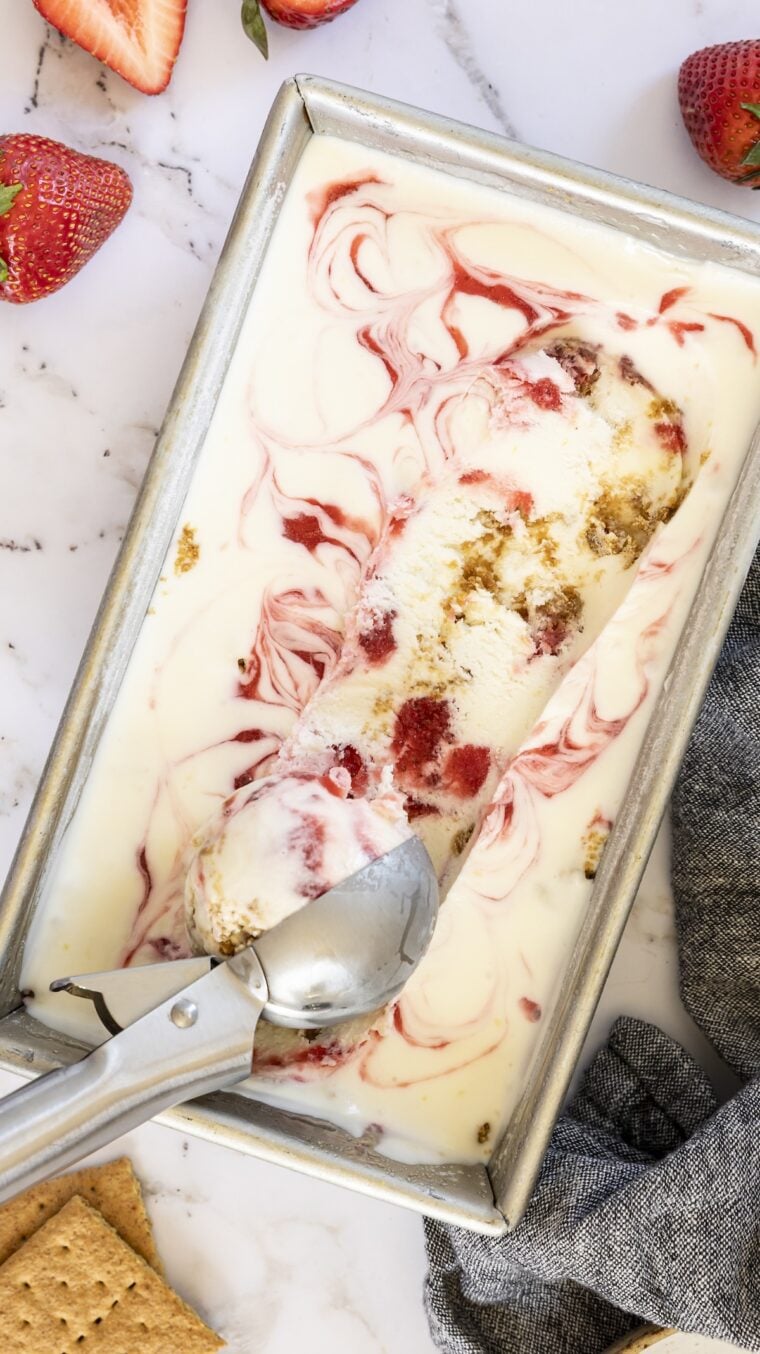 Strawberry Cheesecake Ice Cream in loaf pan with ice cream scoop