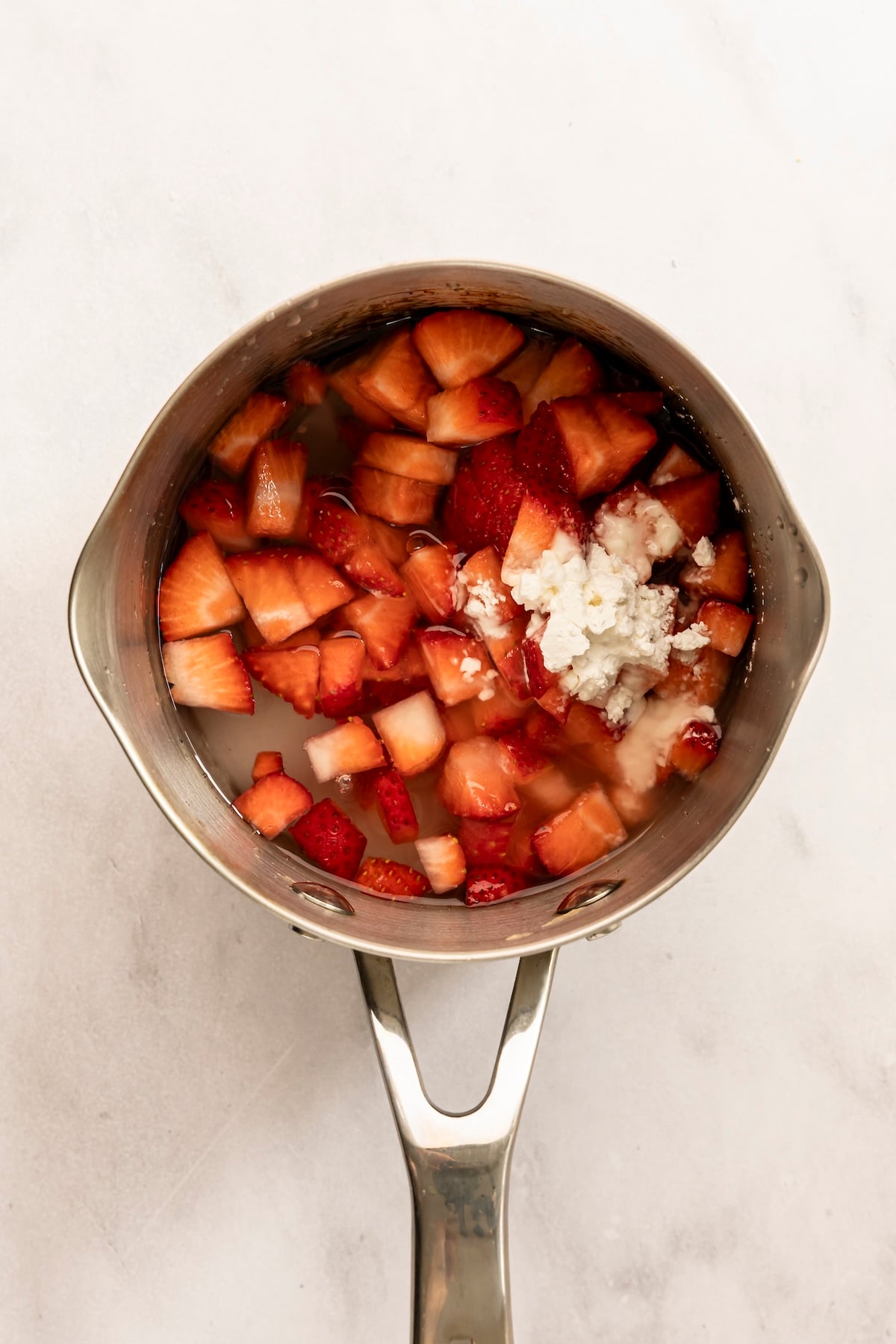 small saucepan with the strawberries, cornstarch, sugar, lemon juice, and water