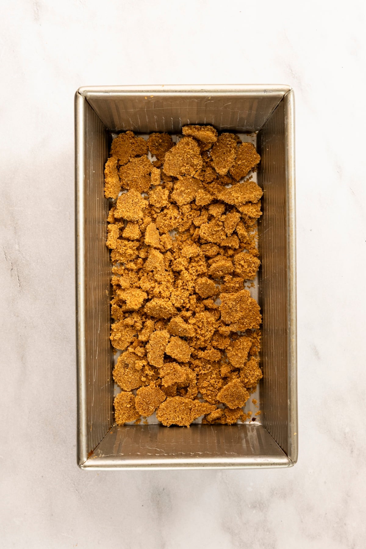 crust crumbles spread on bottom of 9 x 5-inch loaf pan