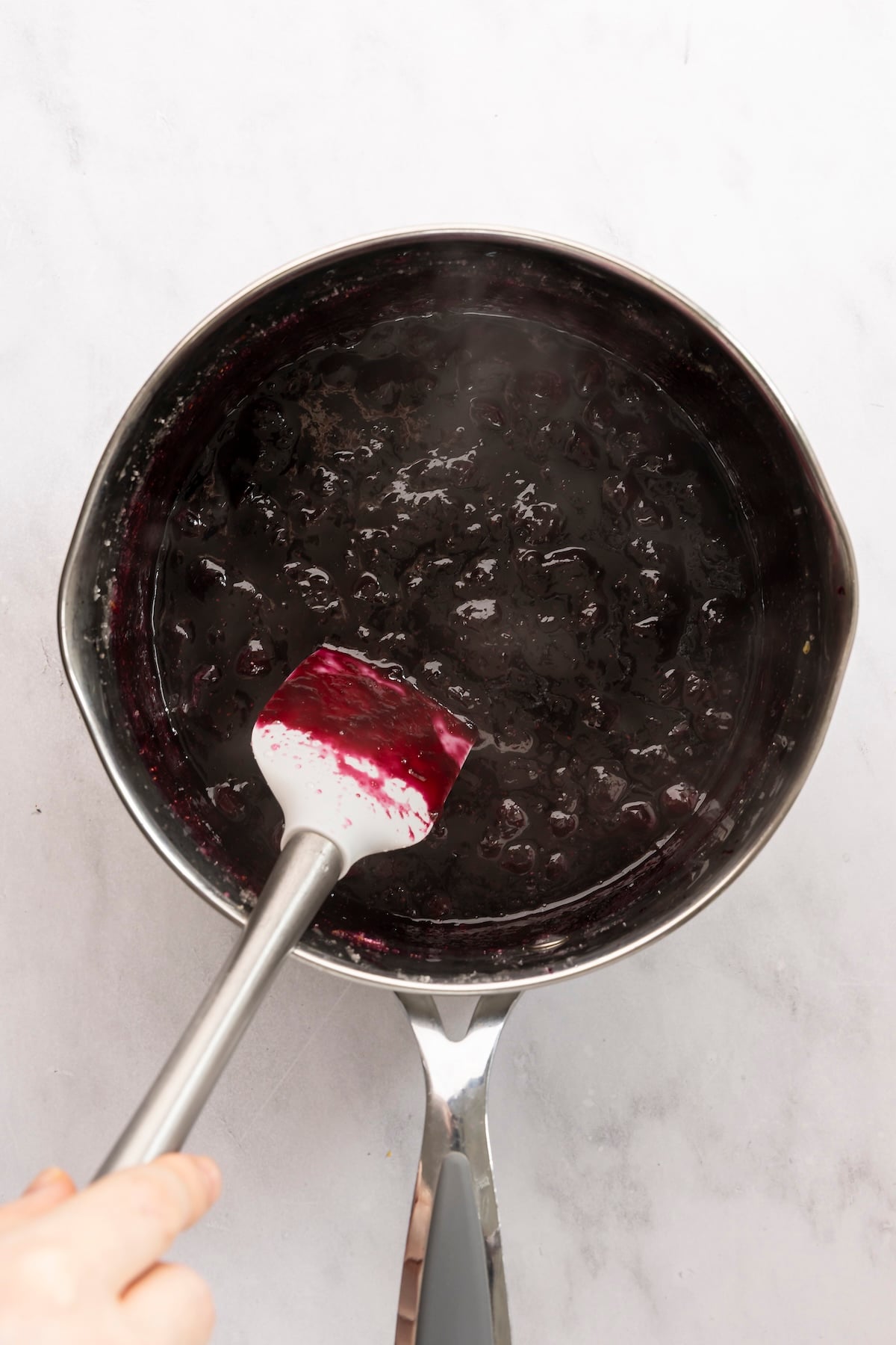 cooking blueberry jam in pot