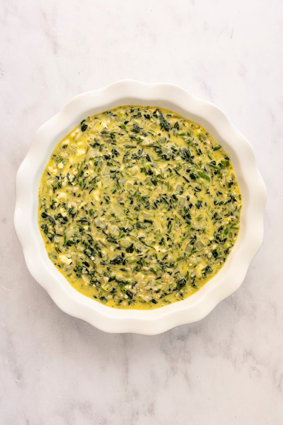 egg mixture in deep dish pie pan