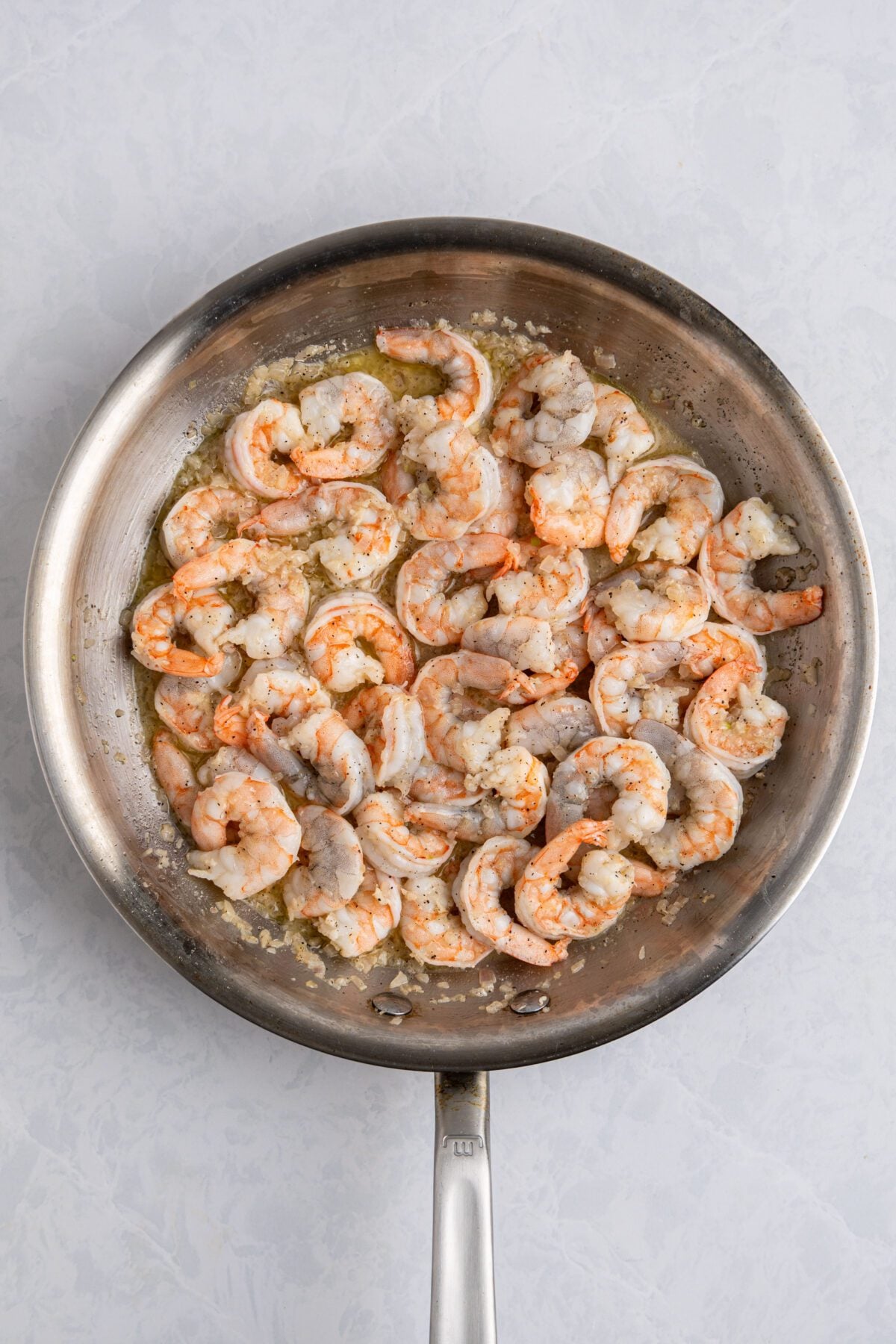 partially cooked shrimp, shallots, and garlic in large skillet