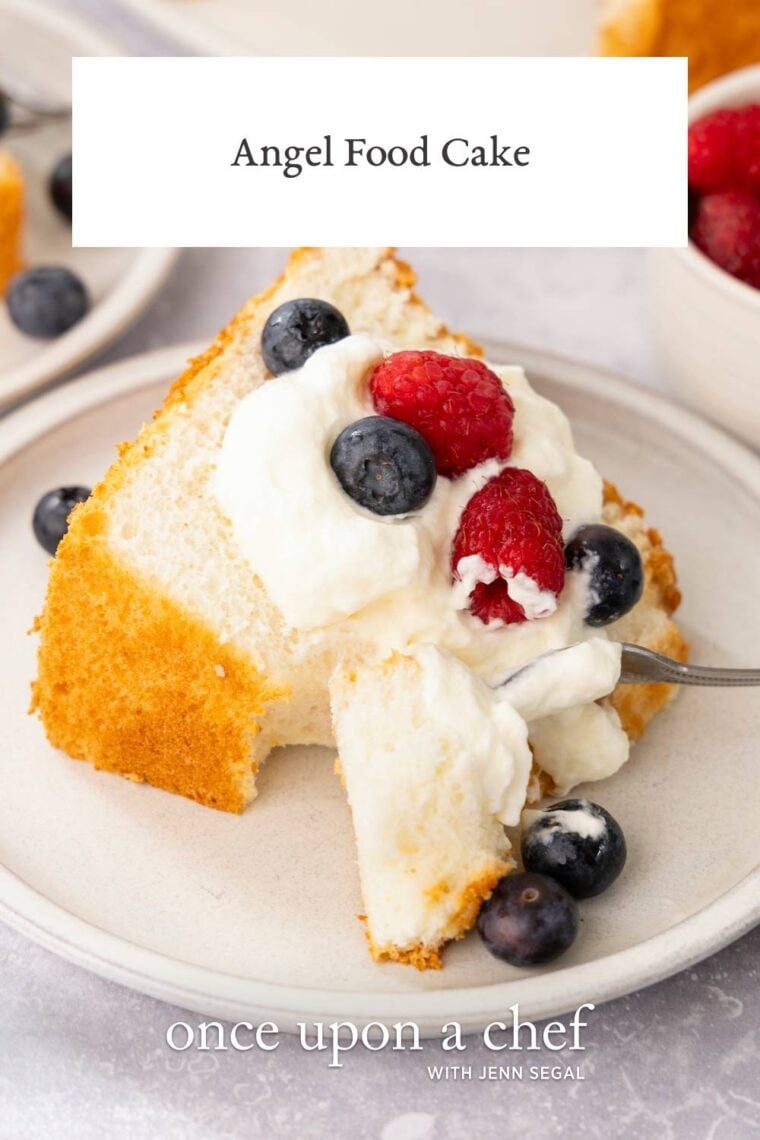 slice of angel food cake topped with a dollop of whipped cream and fresh berries.