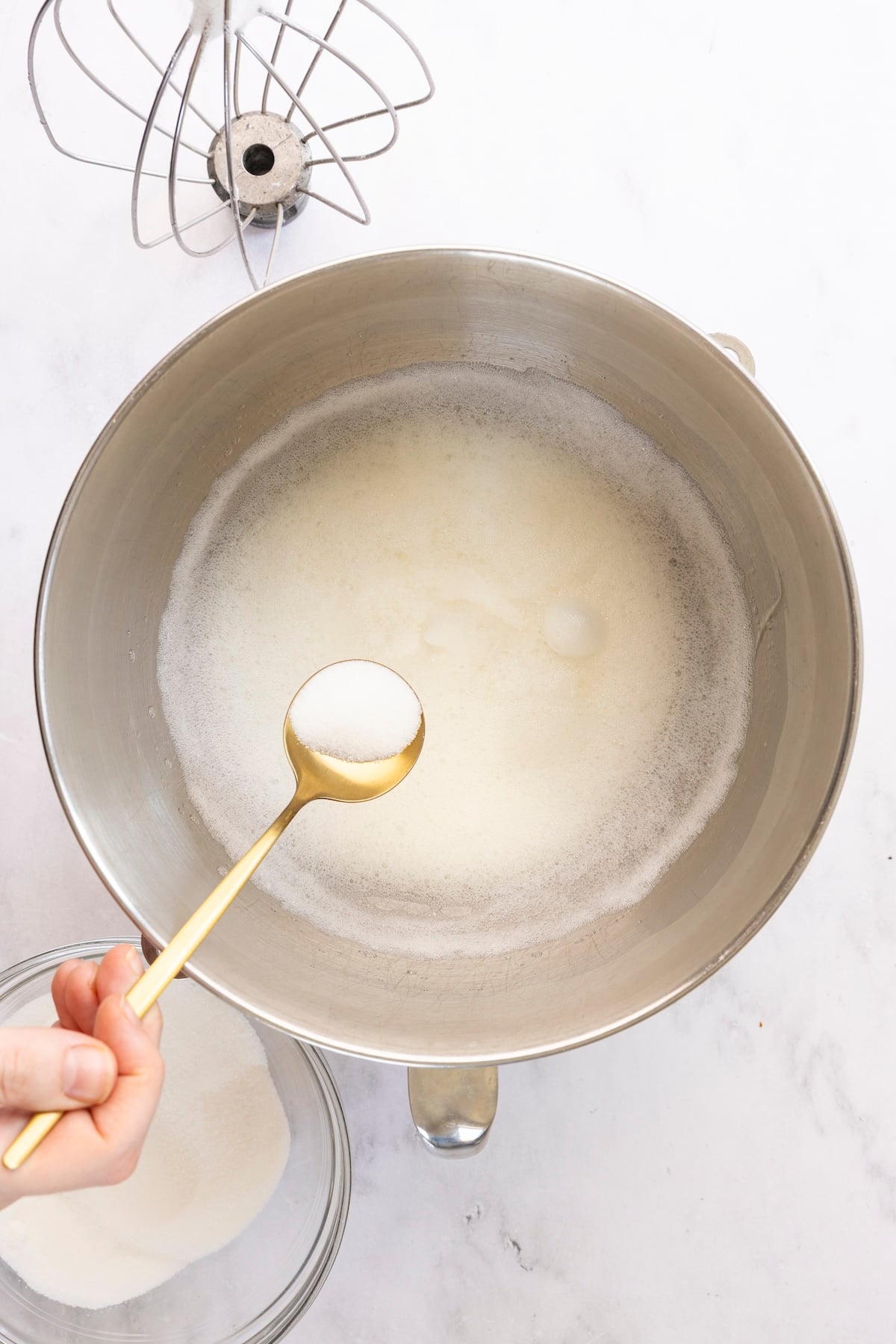 adding sugar gradually to egg whites
