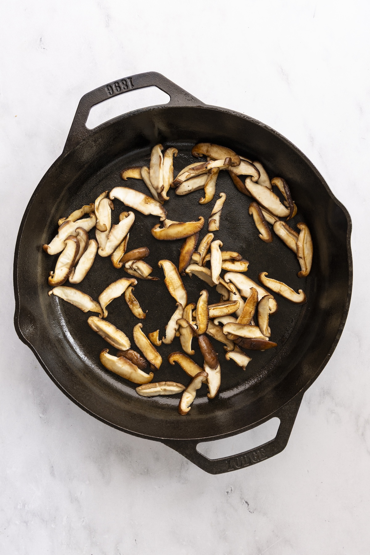 Cooked mushrooms in cast iron skillet.