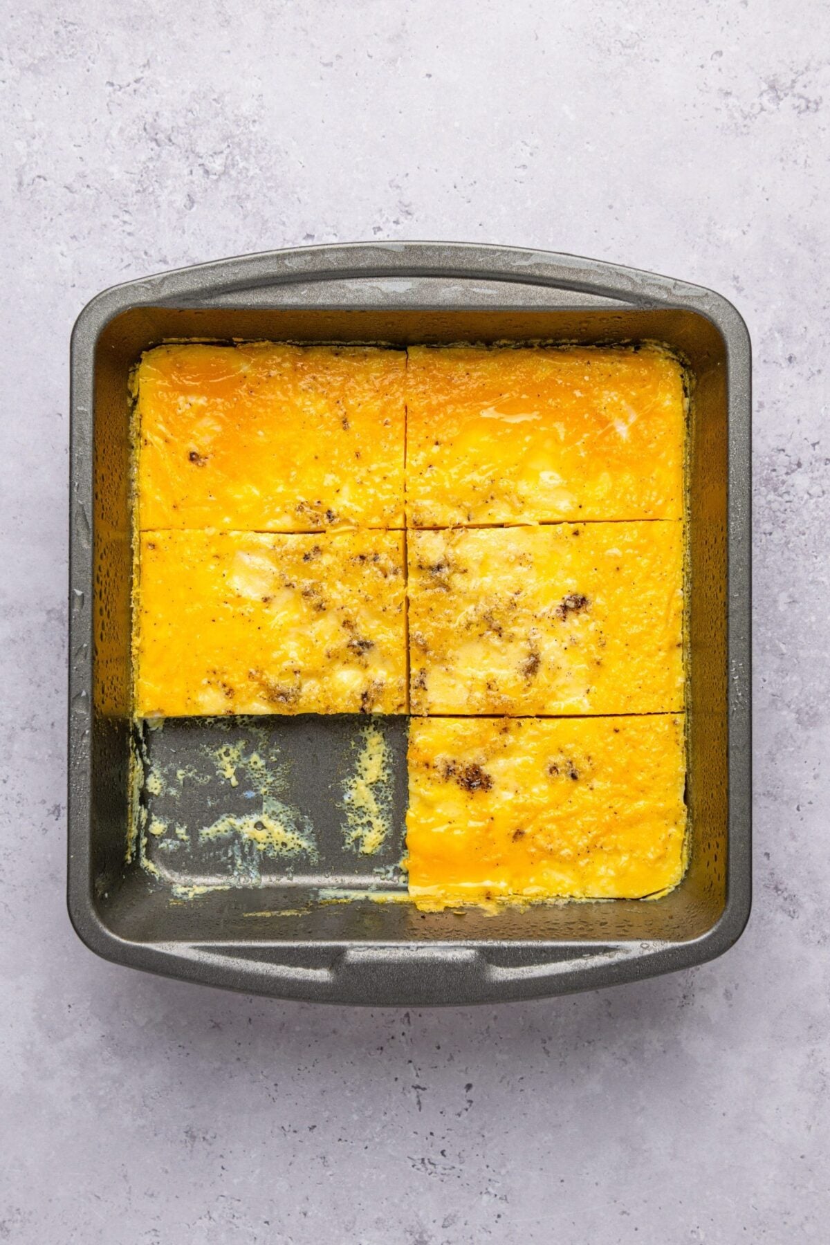 baking pan with cooked eggs sliced into six portions 