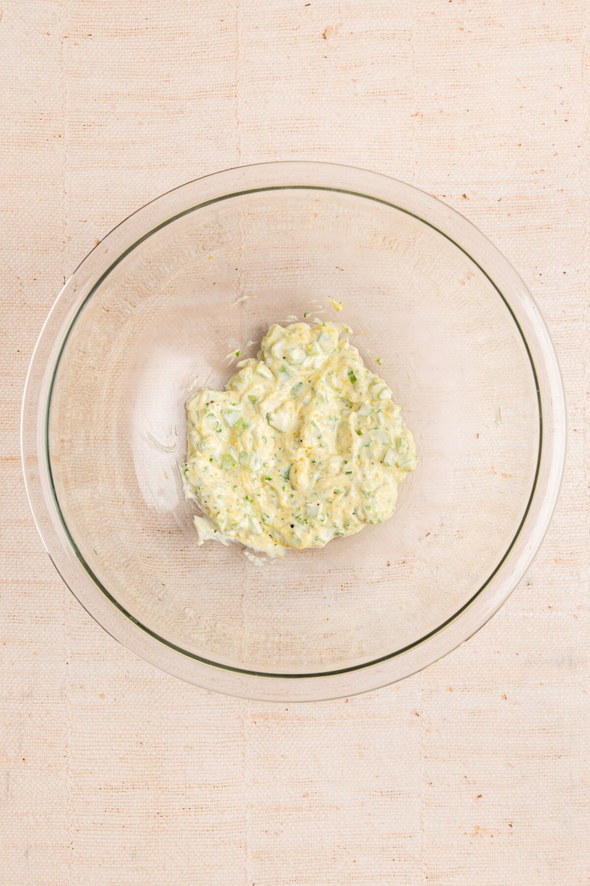 large bowl with mixture of mayonnaise, celery, lemon zest, mustard, chives, salt, and pepper