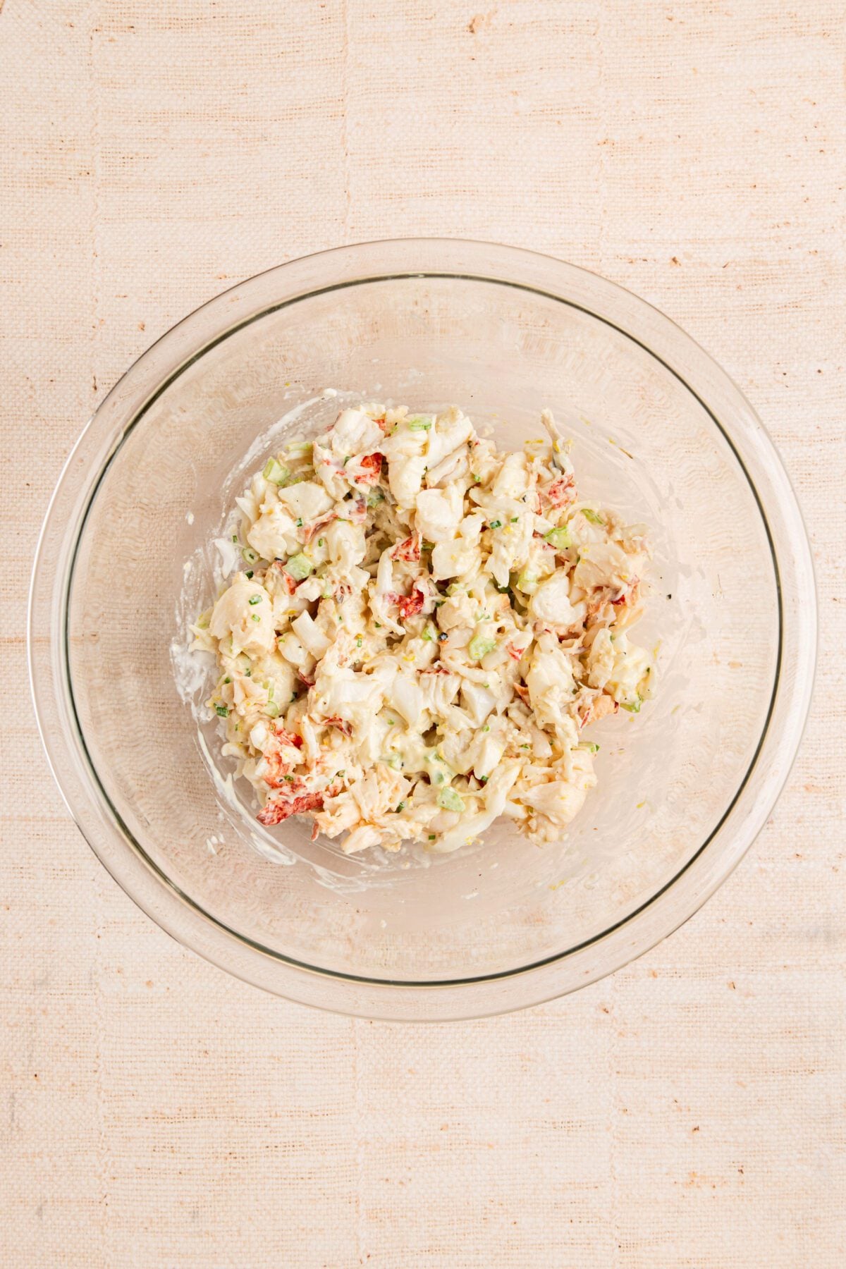 large bowl with lobster meat tossed with mayonnaise mixture