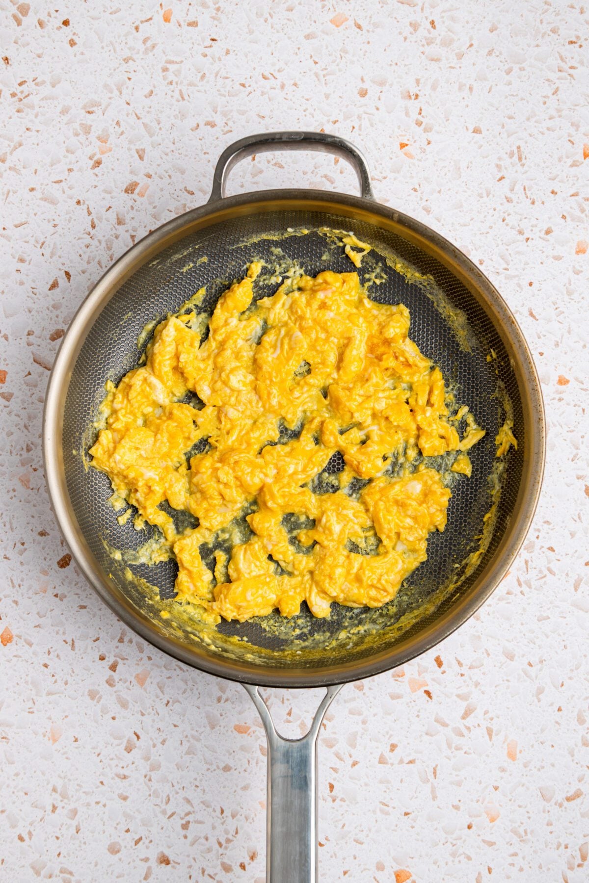 Scrambled eggs in skillet.
