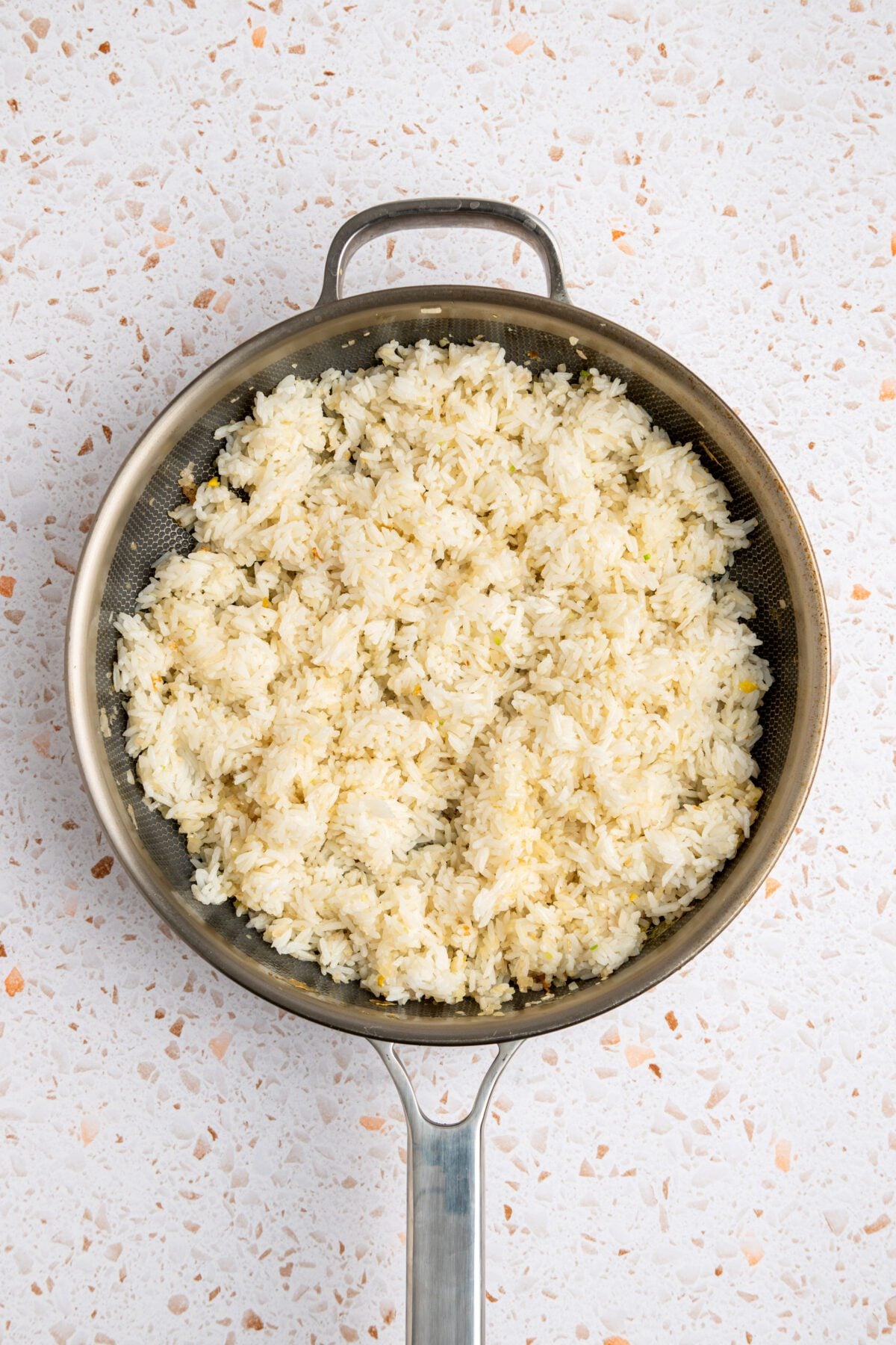 Jasmine rice in skillet with scallions.