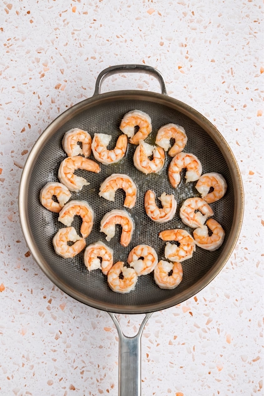 Cooked shrimp in skillet.