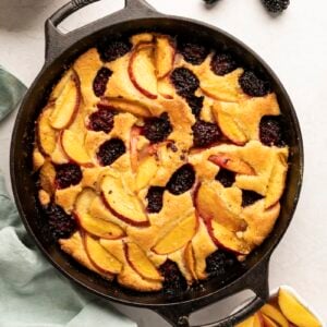 peach blackberry crumble in cast iron skillet on white counter