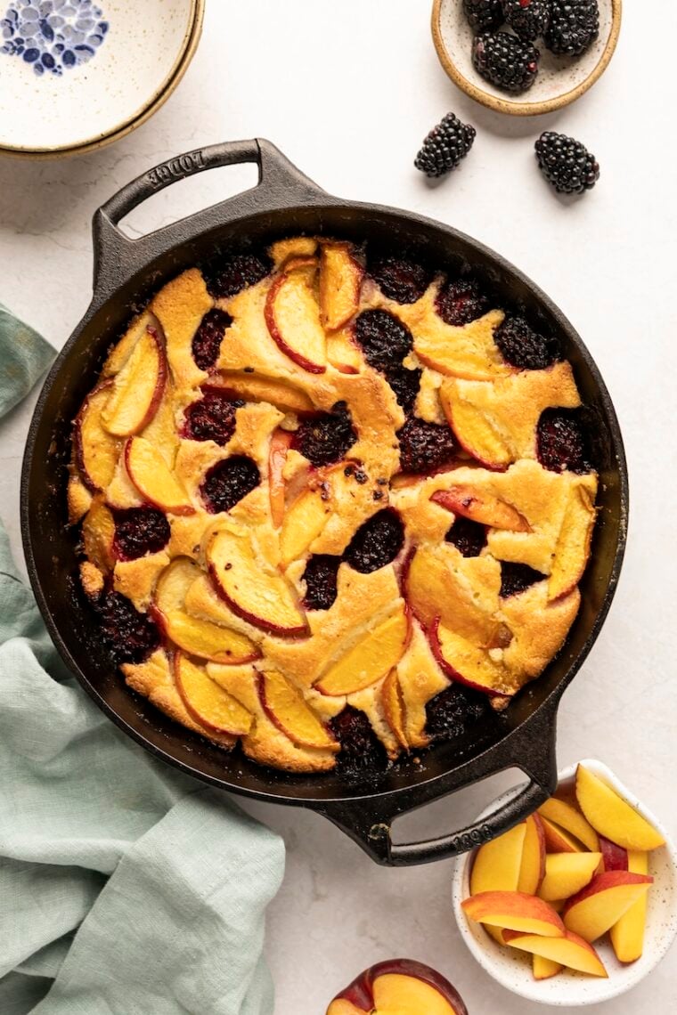 peach blackberry crumble in cast iron skillet on white counter