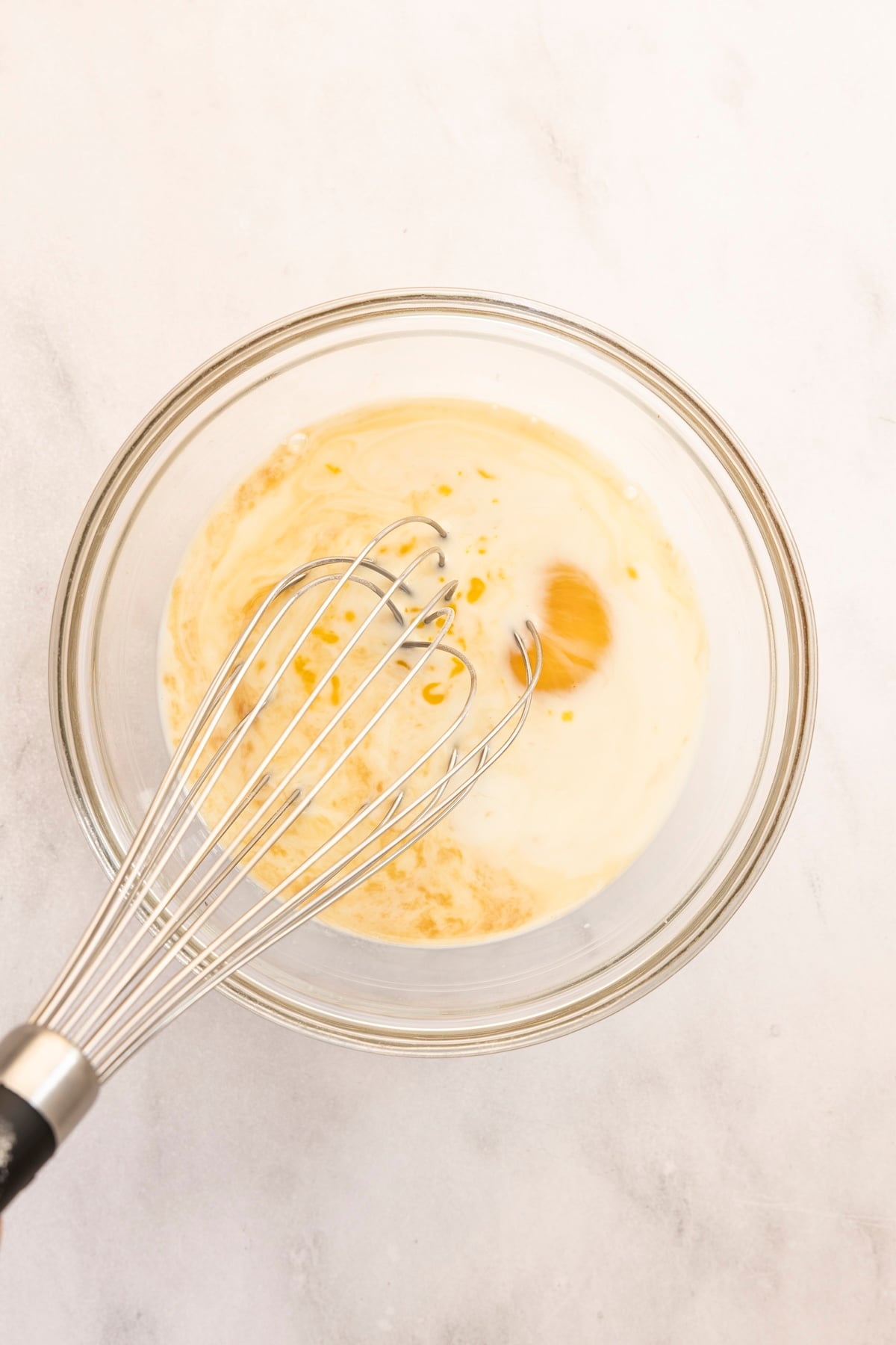 small bowl with milk, egg, and vanilla